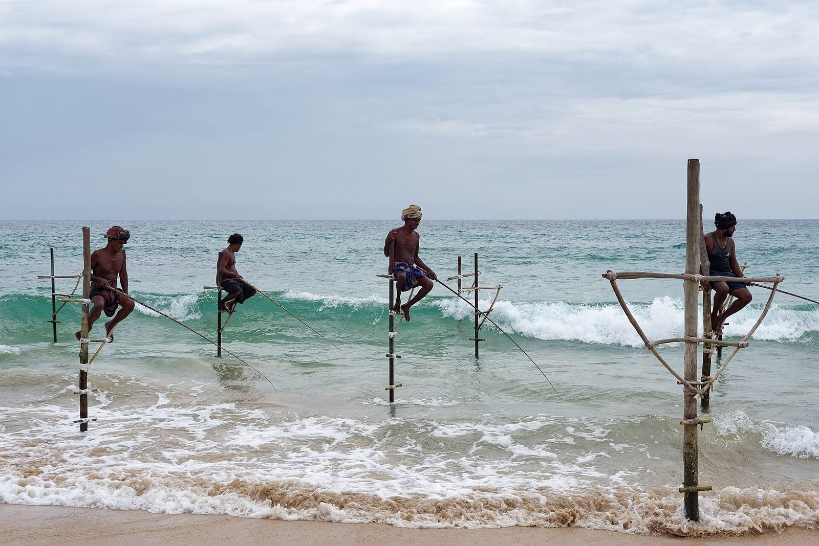 Stilt fishermen at first light